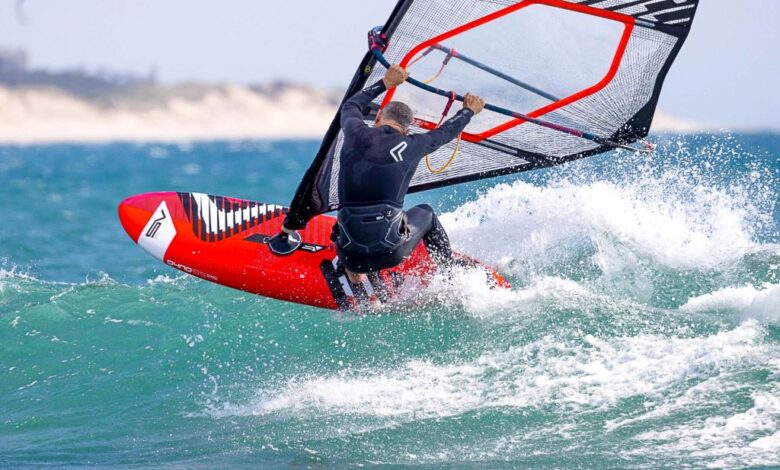 Step-by-step windsurfing preparation with safety gear, wetsuit, and instructions