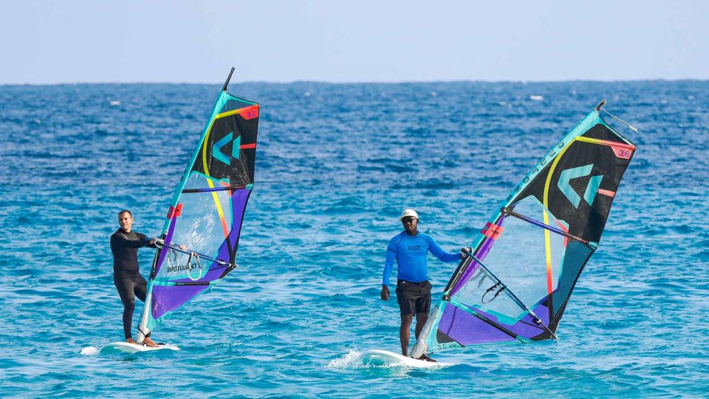 Athlete practicing windsurfing techniques to improve stability and sail control