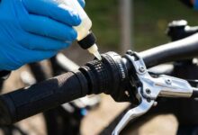 Bike rider inspecting a stiff grip shifter in Austin